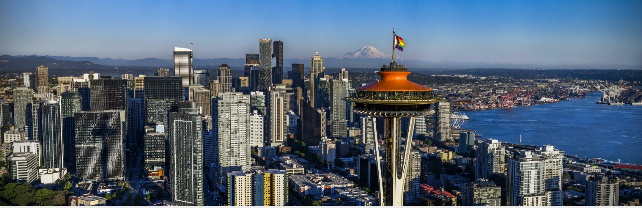 Seattle skyline with the Progress Pride Flag flying atop the Space Needle